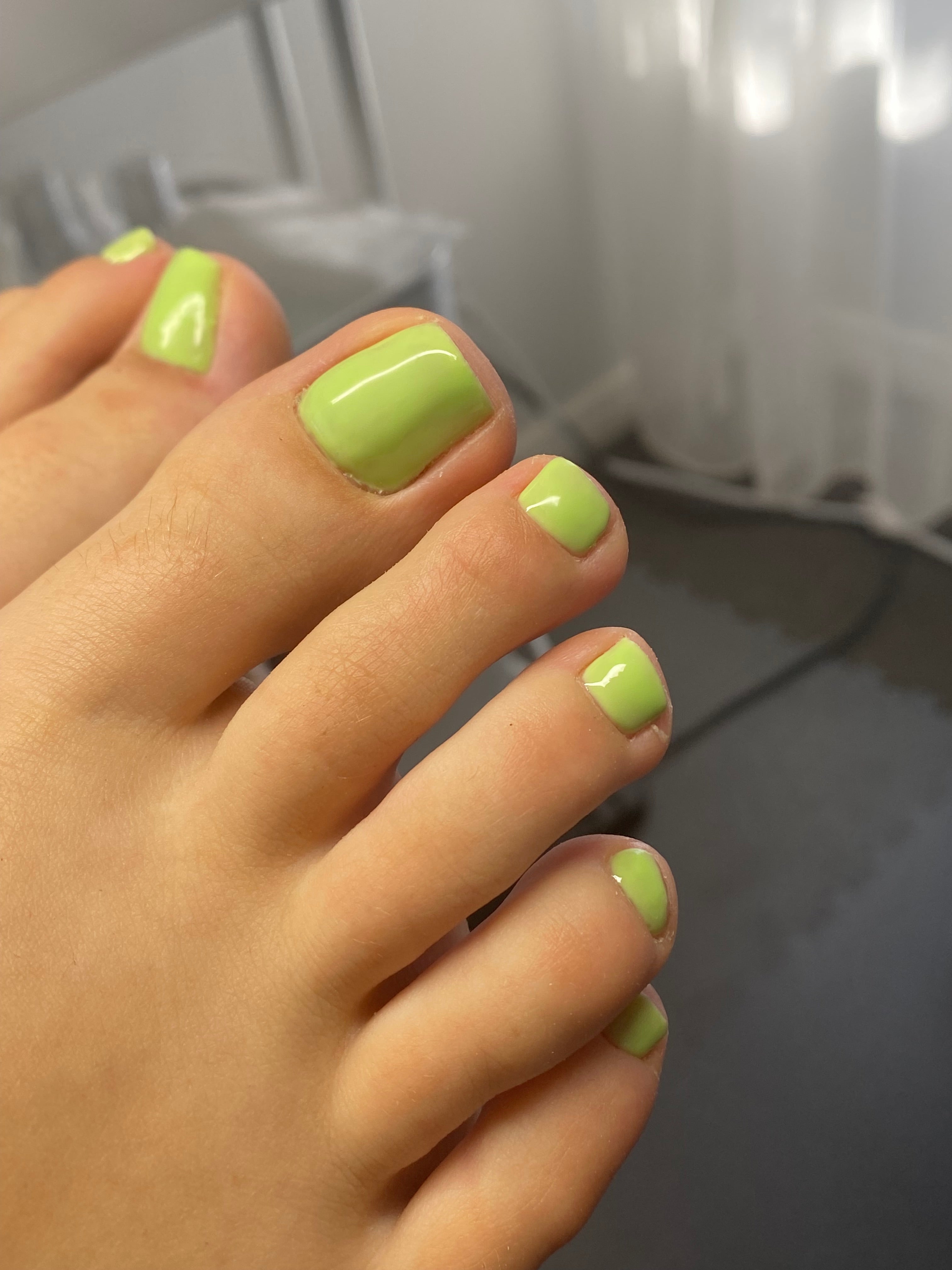 Luxury dry e-file pedicure with clean cuticle work & light green gel polish finish.